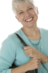 Smiling woman in blue sweater.